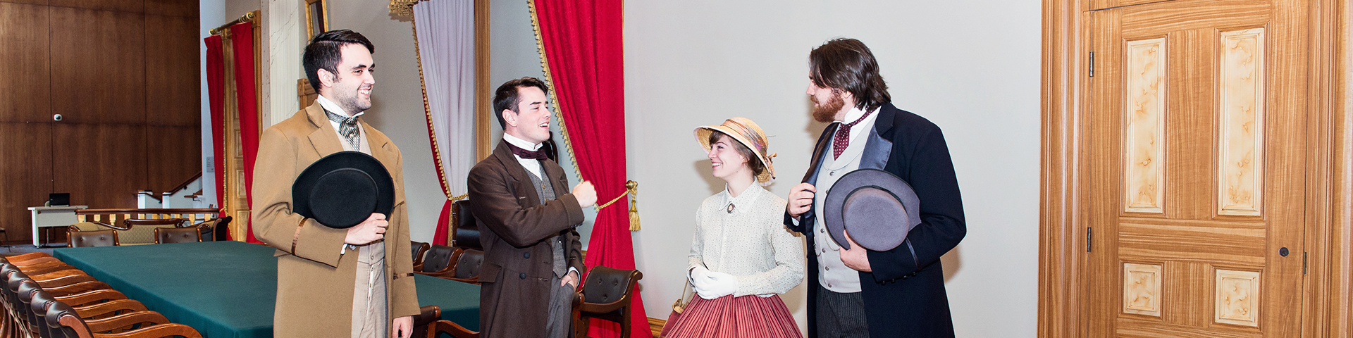 Four people dressed in period costume at Province House