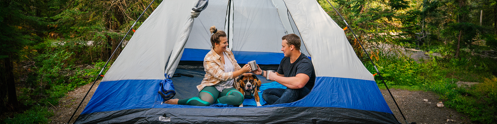 Couple in a tent with a dog
