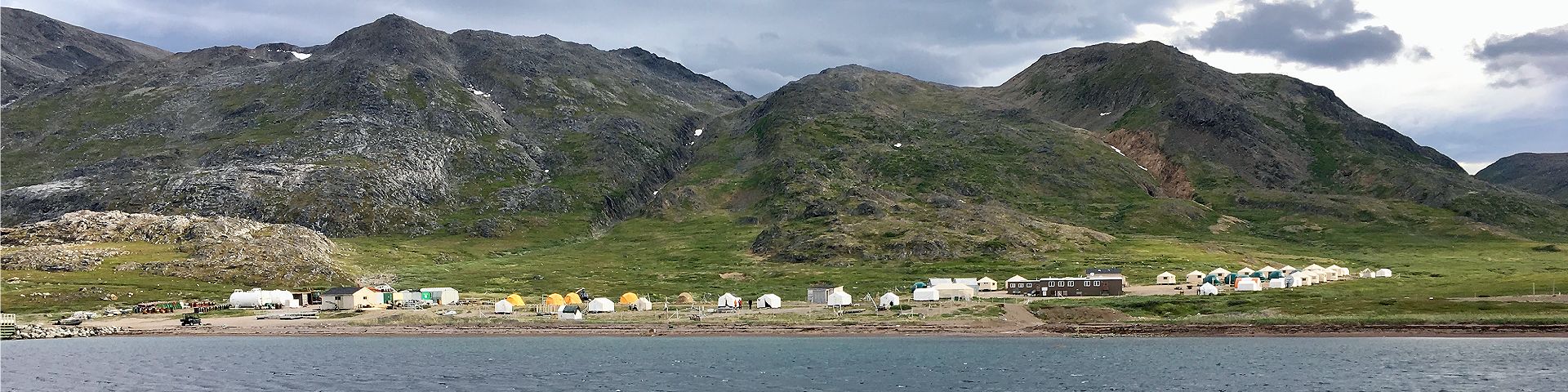 Small buildings and structures along the shore of the base camp at Tongait KakKasuangita SilakKijapvinga-Torngat Mountains National Park