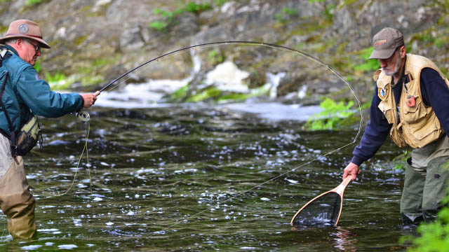 Two fishers fly-fishing.