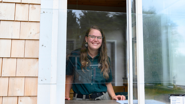 Park staff stands in kiosk ready to greet visitors to PEI National Park