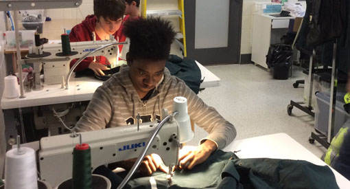 youth learning to sew
