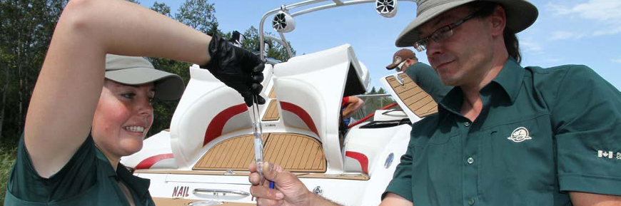 A man and a woman holding up a glass sampling tube.