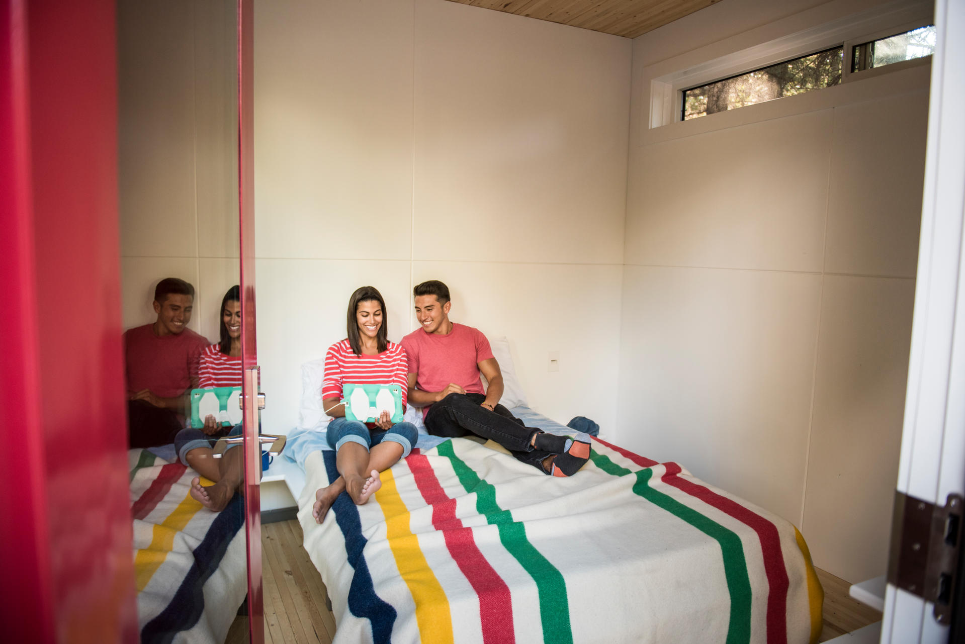 A couple spends time inside the MicroCube accommodations at Wasagaming Campground.