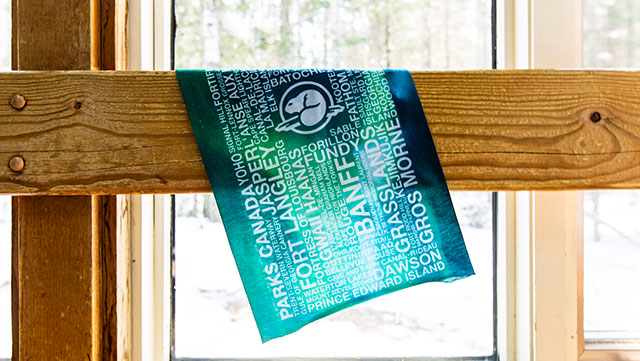 A tuberz with the name of various Parks Canada location layed out on a piece of wood.