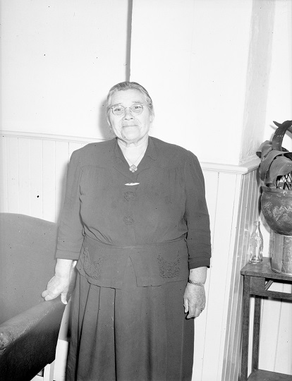 Historical photo of a woman standing and smiling