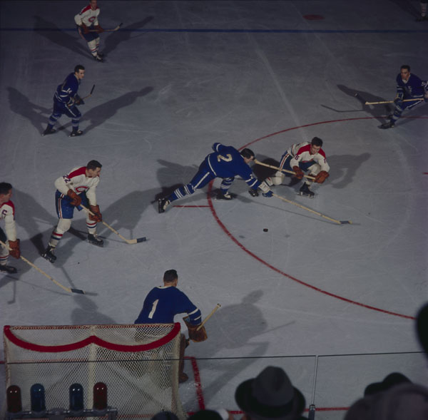 Action shot of two teams playing hockey on ice