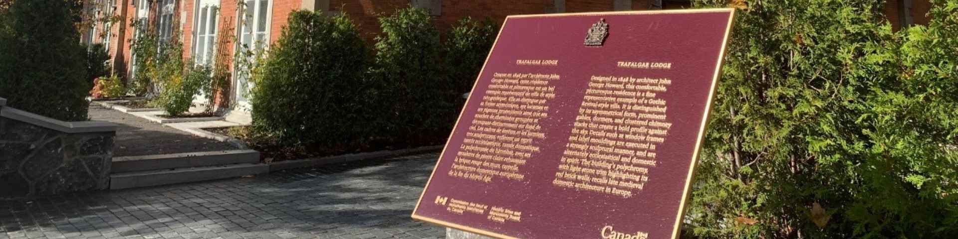 A commemorative bronze plaque in front of a building