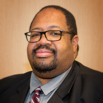 Portrait of a person in a jacket and tie