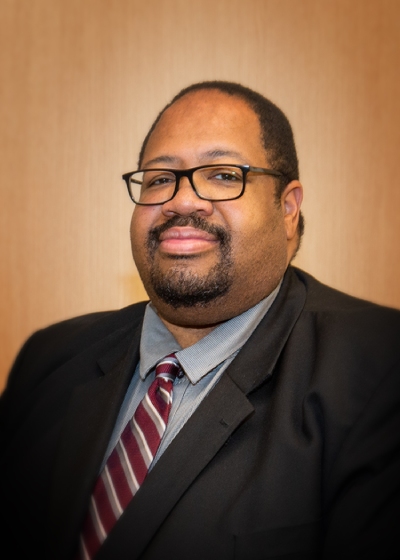 Portrait of a person in a jacket and tie