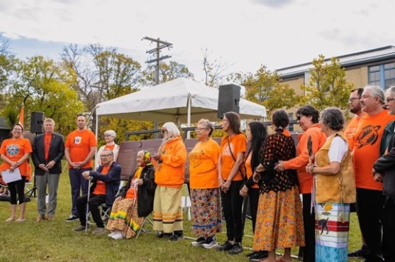 A group of people standing next to commemorative plaques during an event