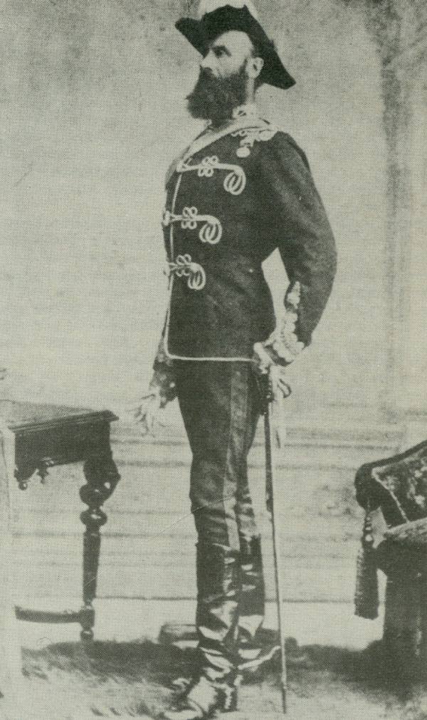 Archival photo of a man standing wearing a uniform