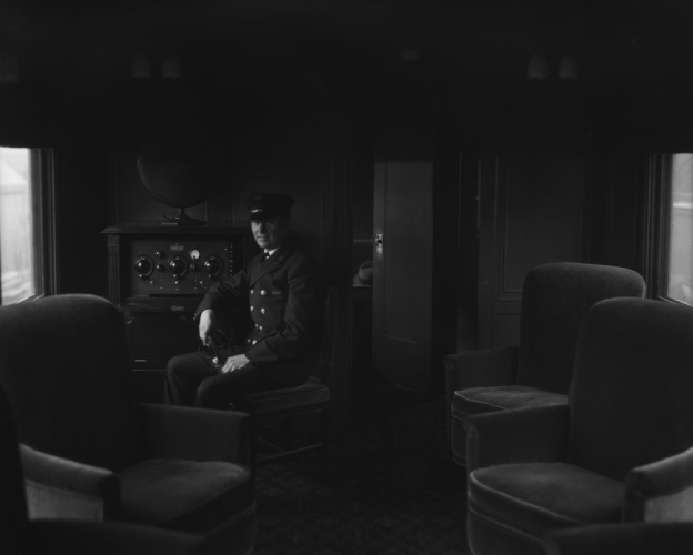 Man siting in a train's music car