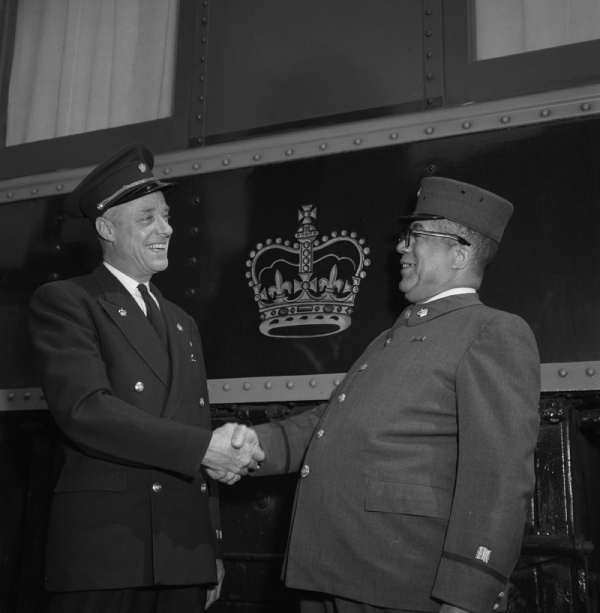 A Black railway porter on the right and a steward, 1958