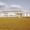 A white building in a grass area