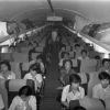 Black and white photo of people seated in a plane