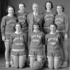 Black and white photo of a group of women and a basketball