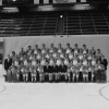 Black and white photo of a hockey team, posing formally from the ice