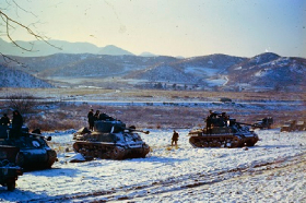 Three war tanks in a Korean landscape