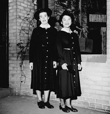 Black and white photo of two women dressed in black