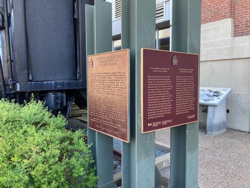 Bronze commemorative plaque on a metal stand