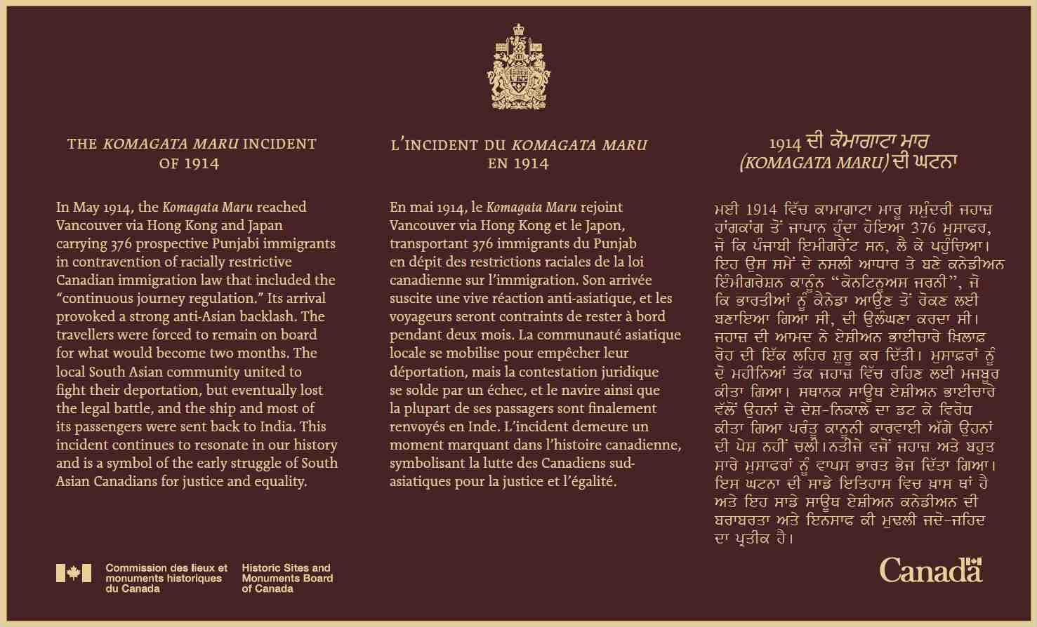 A bronze commemorative plaque in three languages