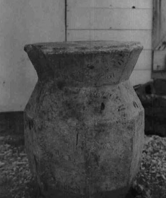 Black and white photo of a large stone made item