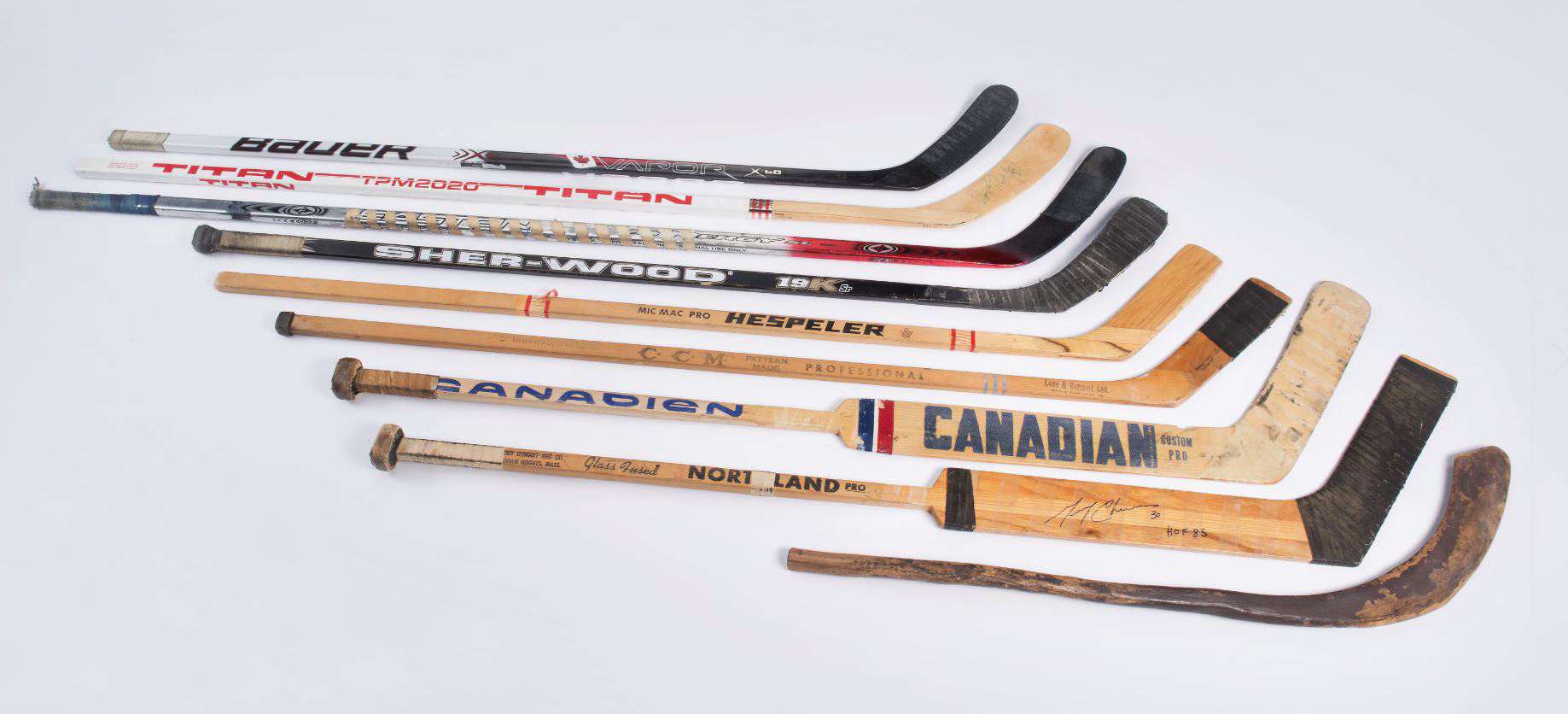 A variety of hockey sticks used throughout modern history