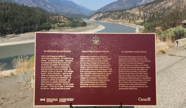 Bronze commemorative plaque in front of a landscape