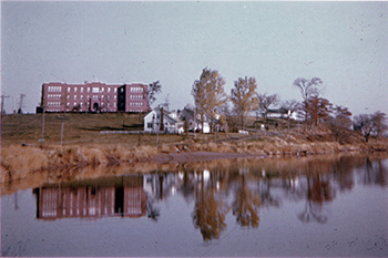 A building by the water with trees