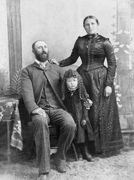 Historic black and white image of a family sitting for their portrait