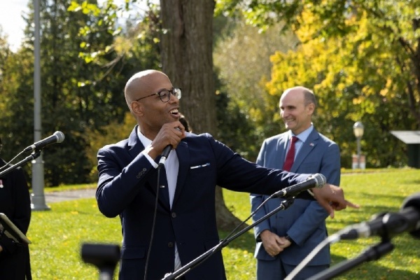 A person singing with a microphone in an outdoor setting