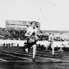 black and white photo of a women during a running race