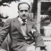 Paul-Émile Borduas seated in front of an art piece, 1946