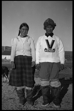 Black and white image of a man and a woman standing beside each other