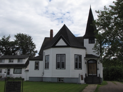 Large house with commemorative plaque in front