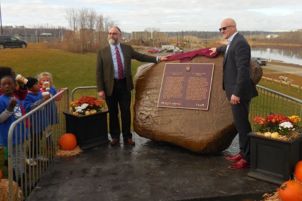 Two man unveils a new commemorative plaque