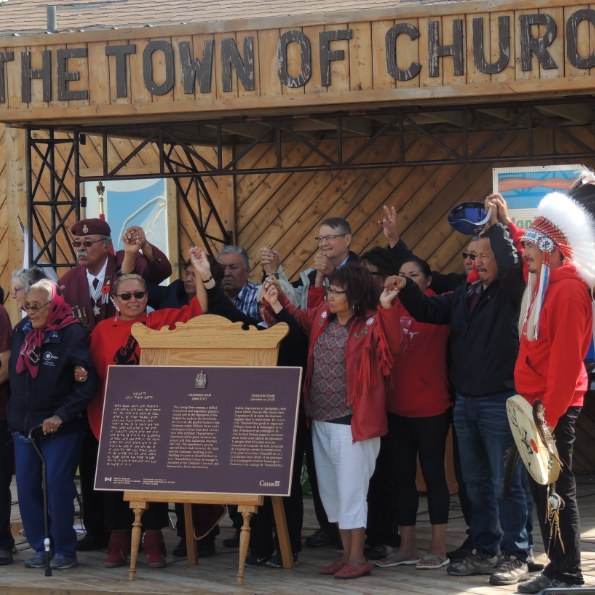 Photo of a group of people at a plaque unveiling 