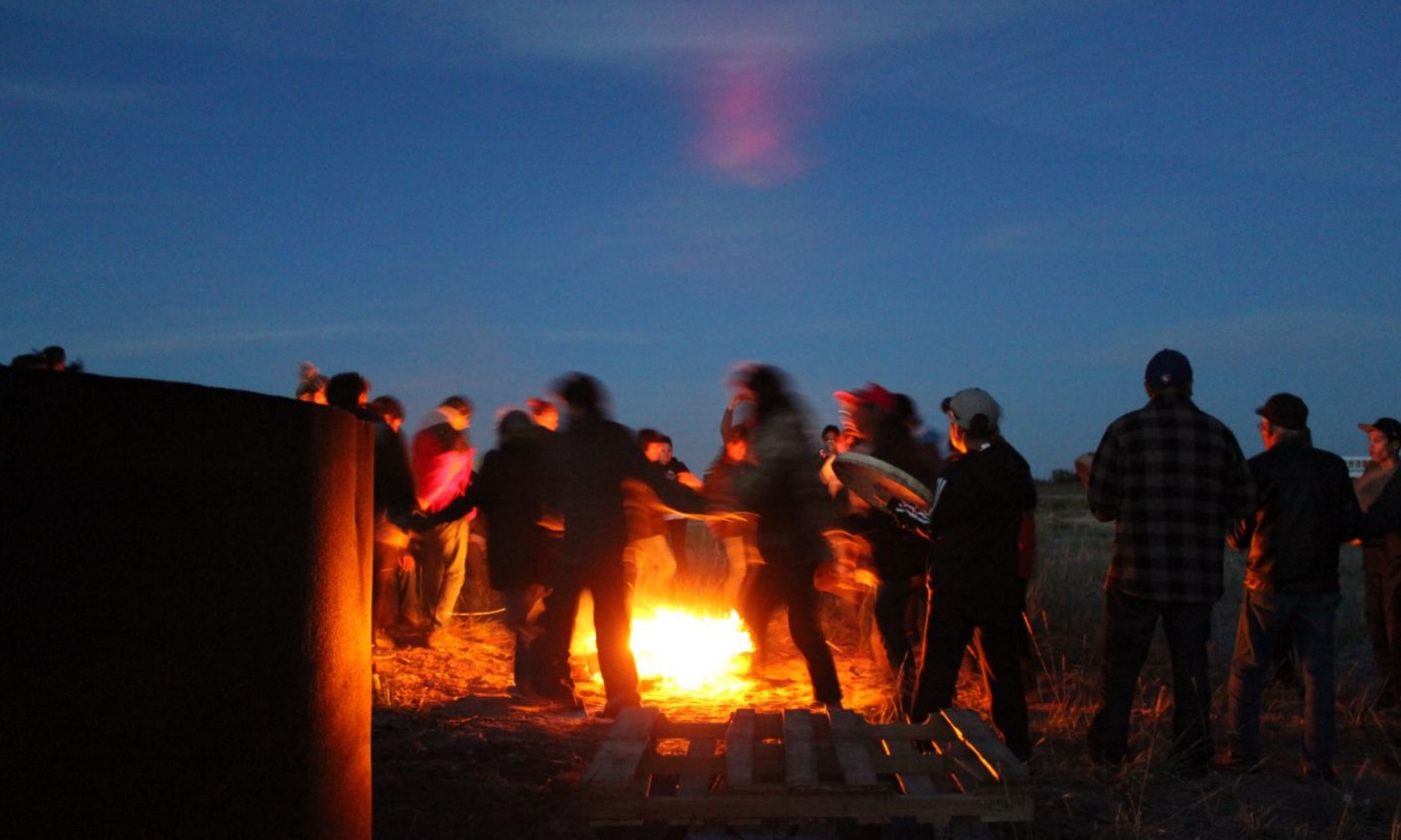 Photo of a group of people around a fire