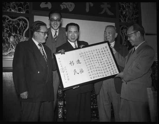 Man smiling and holding a document 