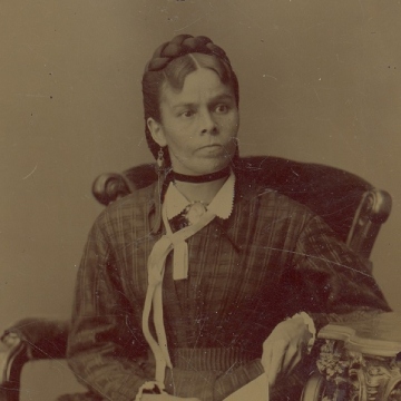 Archival photo of a women seated on a chair