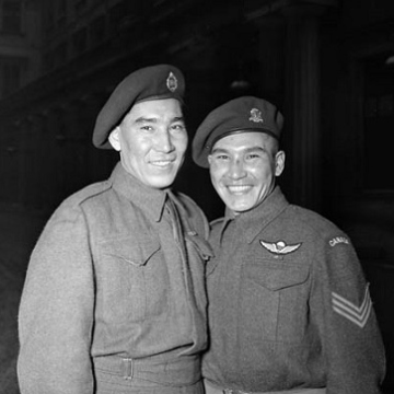 Black and white portrait of two soldiers smiling 