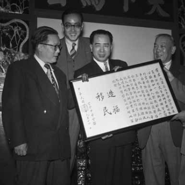 Man smiling and holding a document 