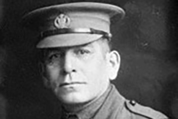Black and white photo portrait of a man in a uniform