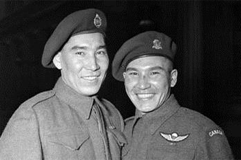 Black and white photo of two man in uniform smiling