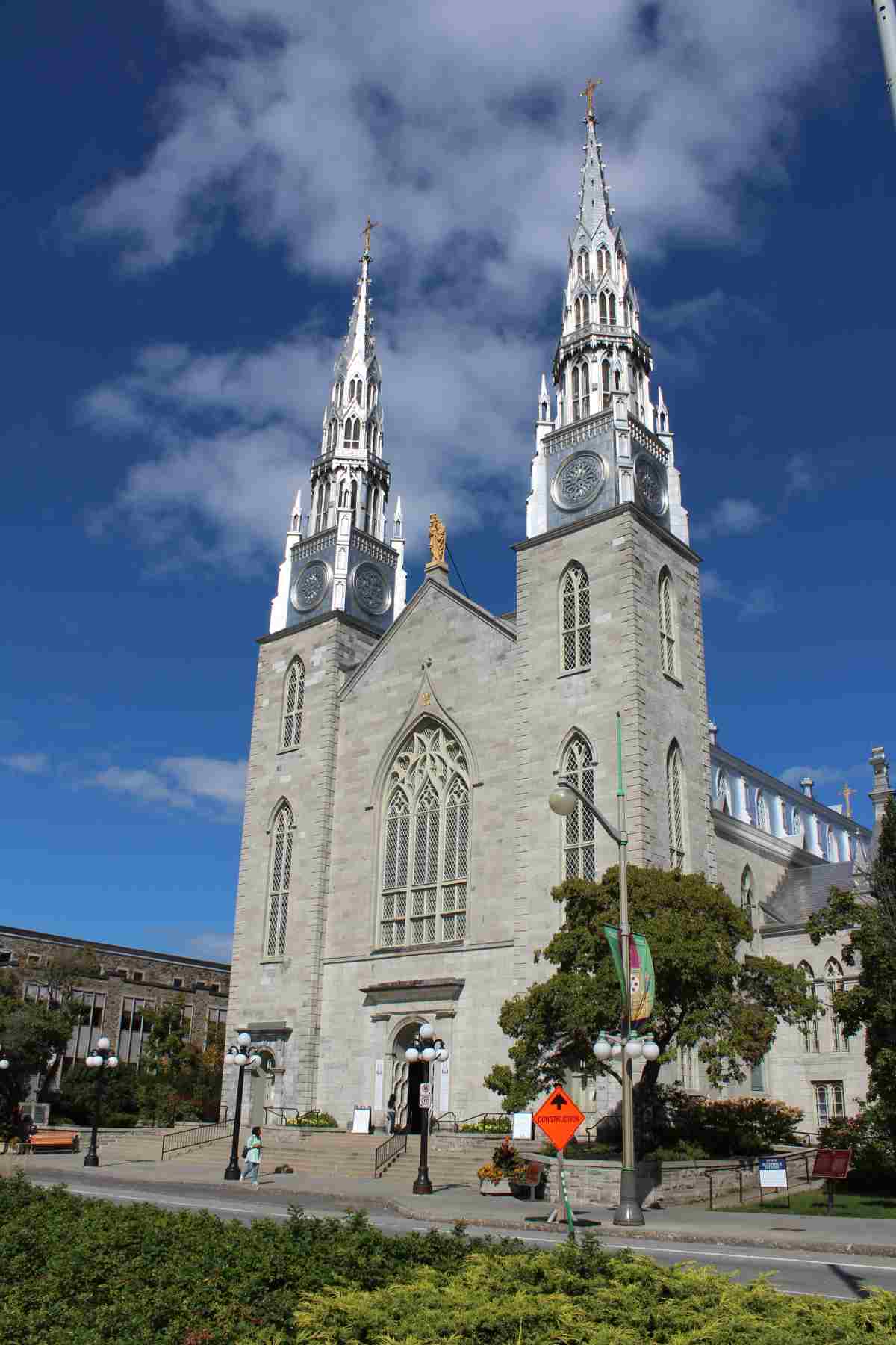 Large grey church with two towers and blue sky in the background