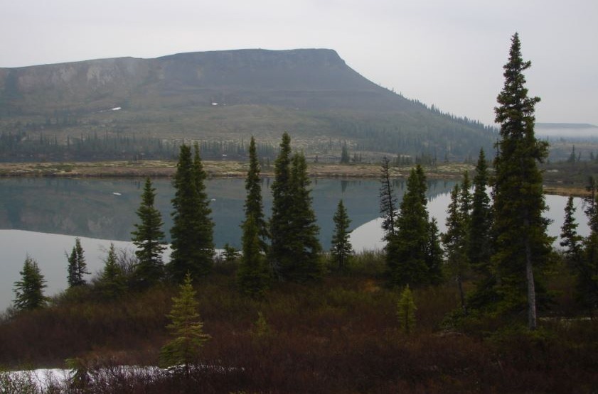 Image of a landscape showing water and a mountain 