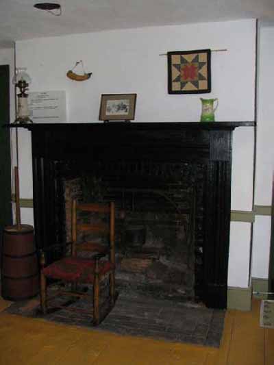 A fireplace and a chair inside a house