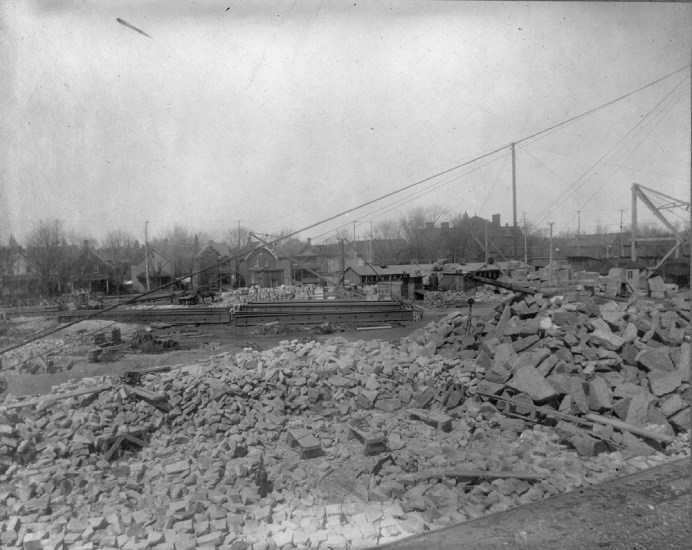 Black and white photo of a field, representing the Victoria Memorial Museum under construction in Ottawa, Ontario