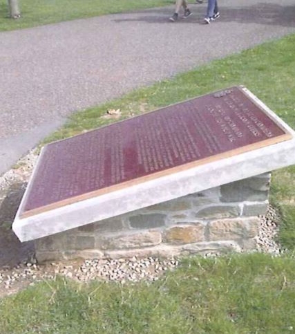 Bronze commemorative plaque on its stand